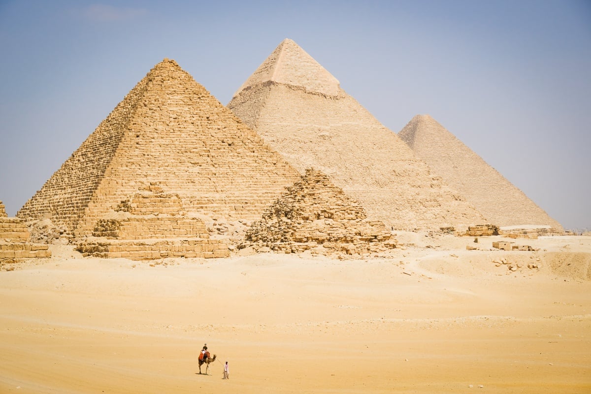 Camel walking in the distance at the Great Pyramids of Giza in Egypt