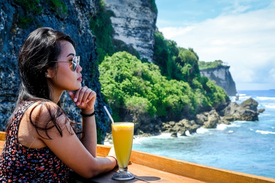 My woman with a drink at the Suluban cliff restaurant in Bali