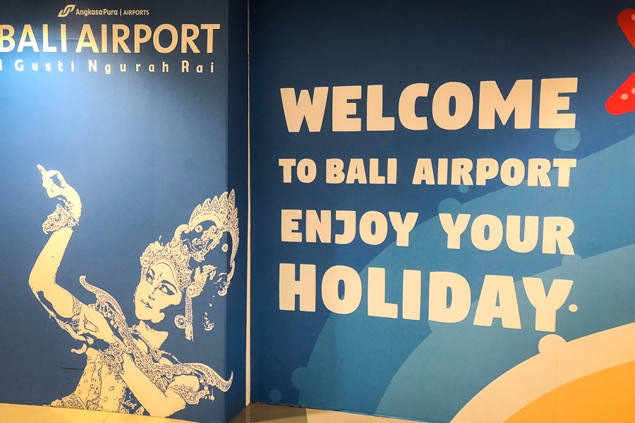 Welcome sign with a Balinese dancer at the Bali airport