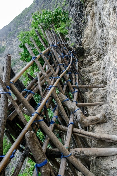 Steep trail and wooden railings at Pererenan Cliff in Nusa Penida, Bali