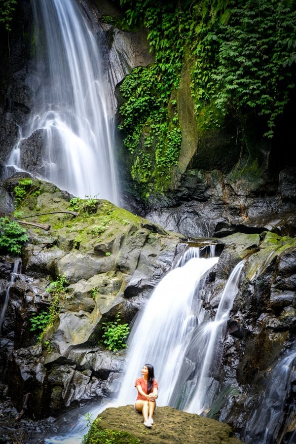 My woman sitting at Pengibul Waterfall in Bali