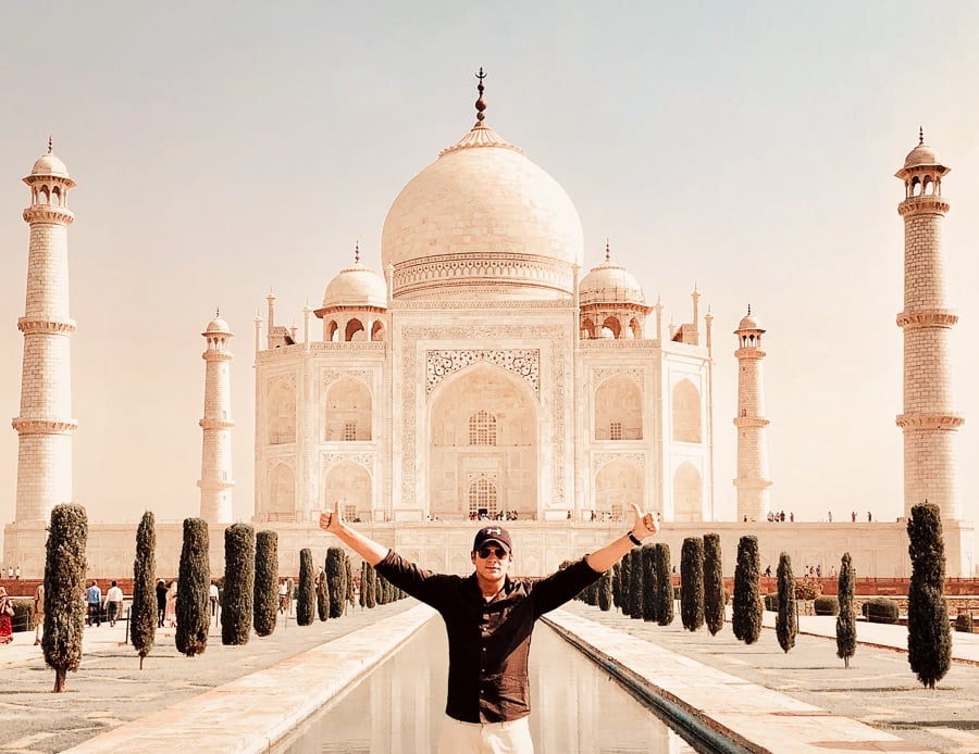 Travel guy posing at the Taj Mahal in Agra, India