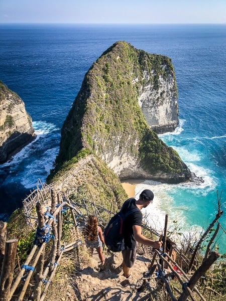 Tourists hiking down to Kelingking Beach in Nusa Penida, Bali