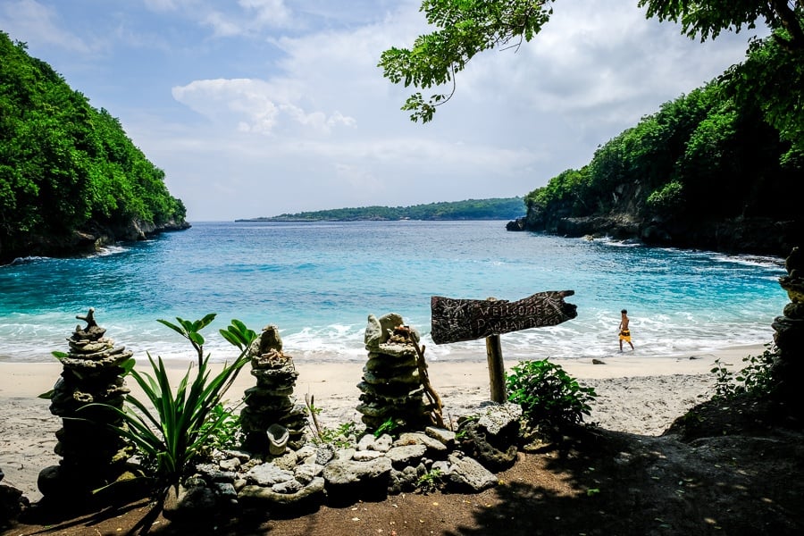 Tourist walking on the sand at Pandan Beach in Nusa Penida, Bali