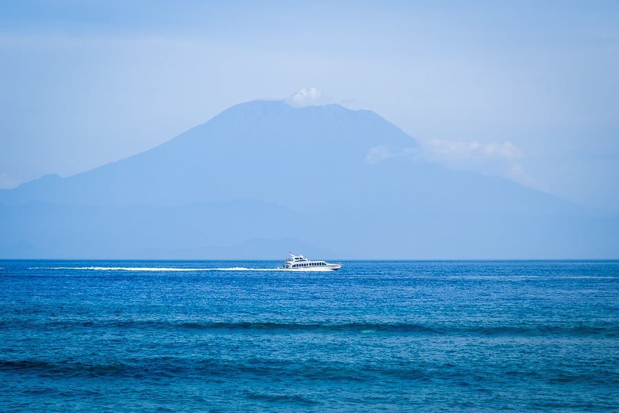 Speedboat driving past Mount Agung on the way to Nusa Penida Bali